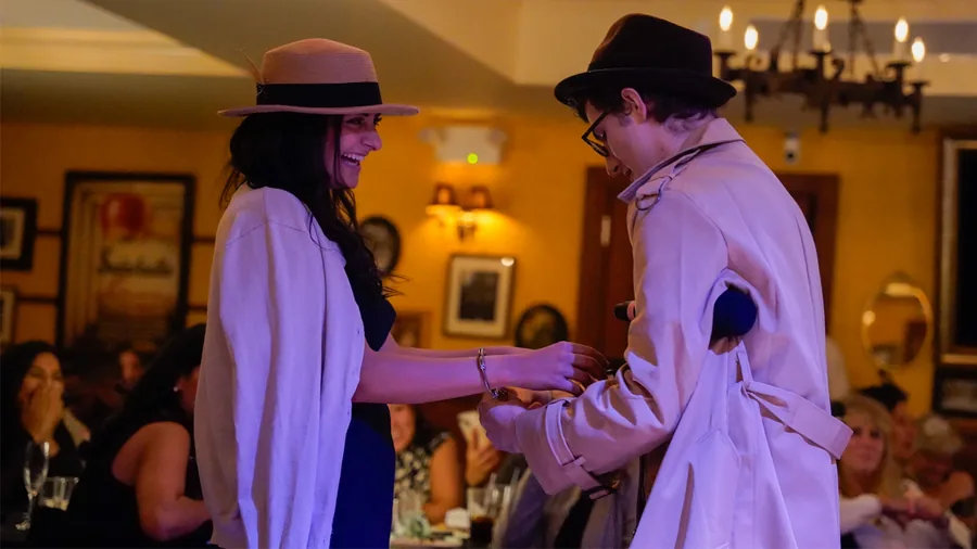 A Murder Mystery Company detective questioning a guest at a Grand Rapids show