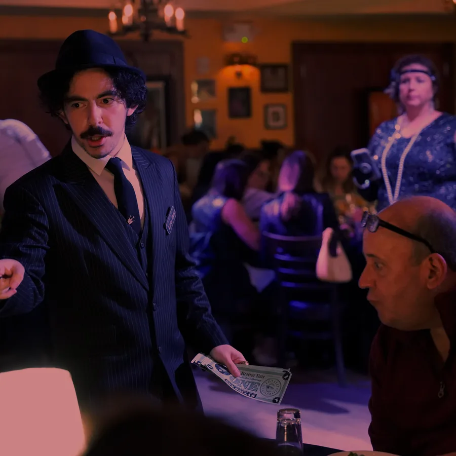 A Murder Mystery Company actor working the room at a Grand Rapids show