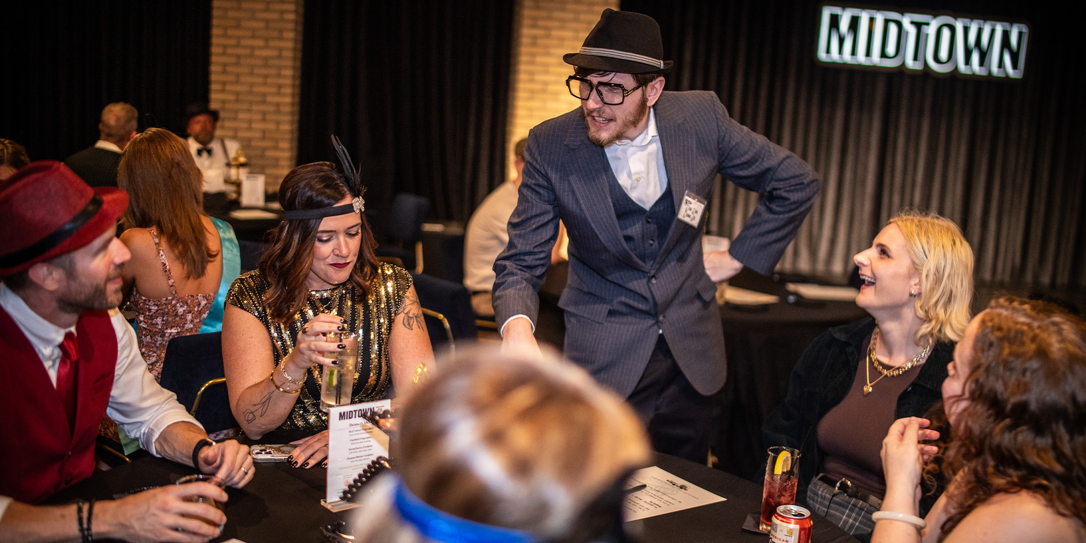 Guests at a Murder Mystery Company public dinner show in Grand Rapids